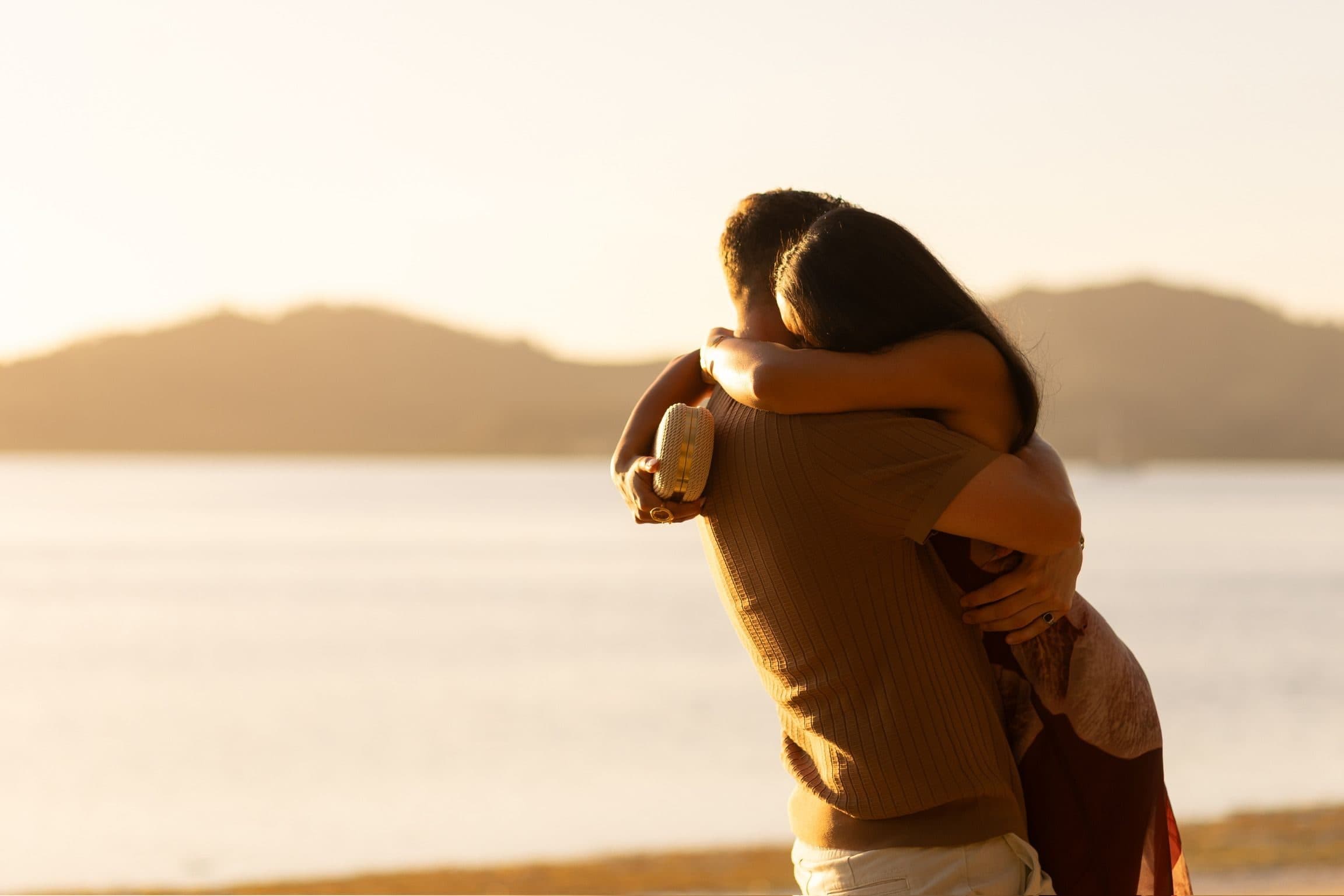 Nicole and Alex embracing at sunset