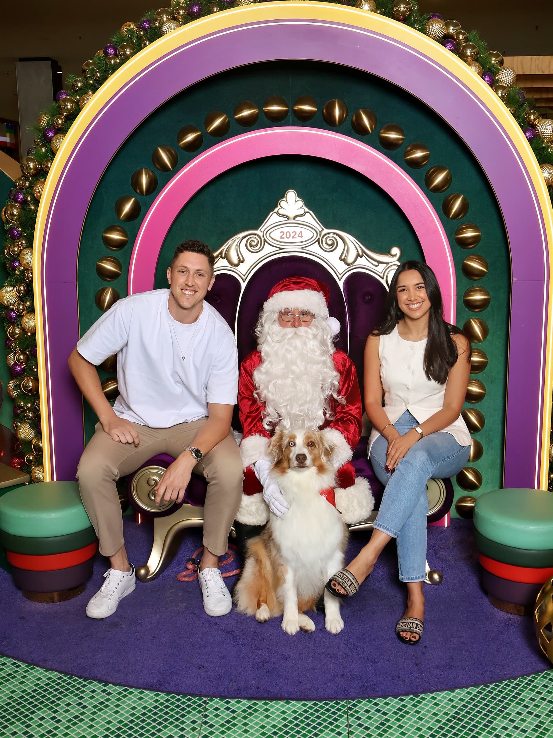 Nicole, Alex and their dog visiting Santa